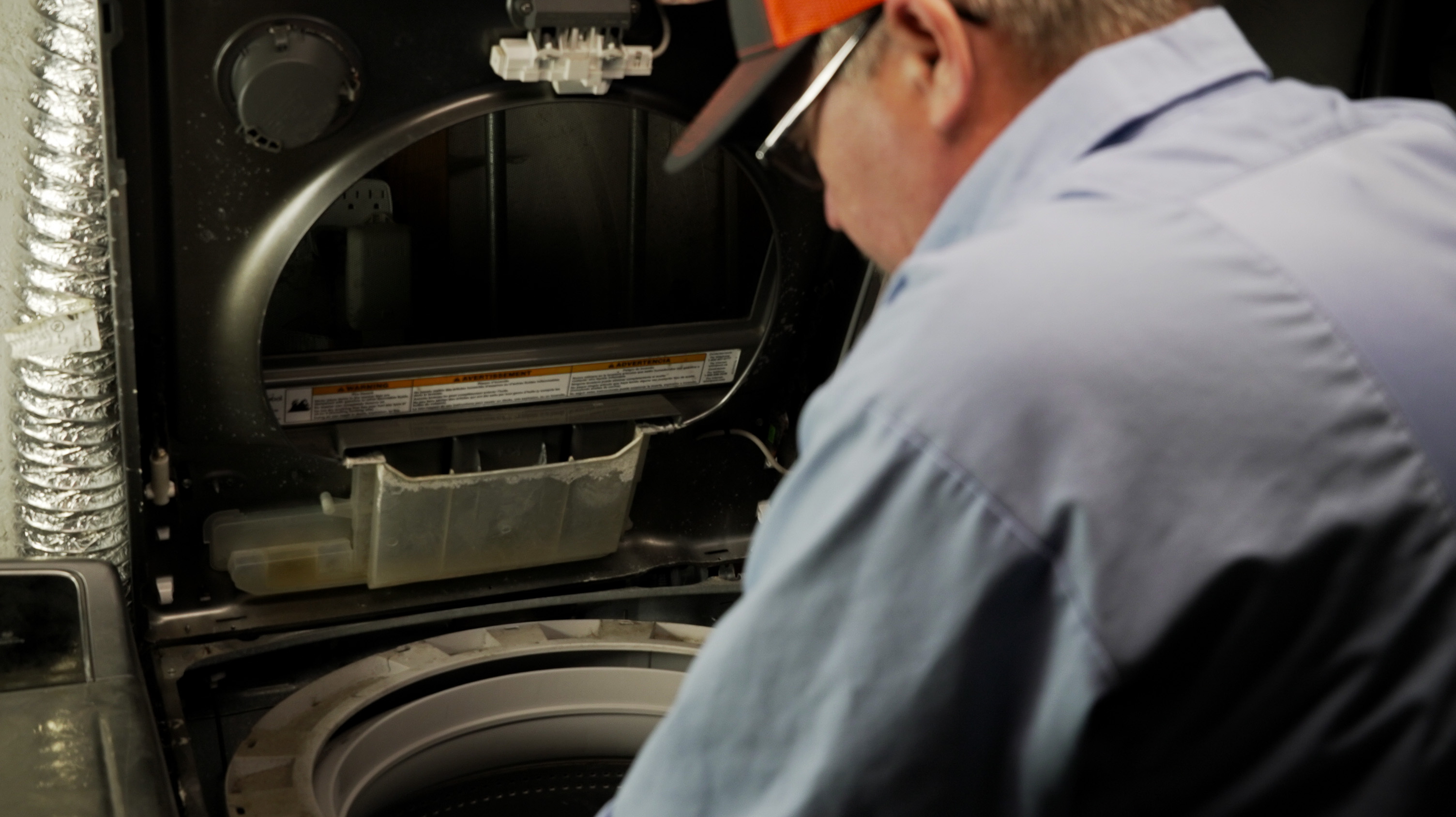 Mr. Appliance of Spokane Valley Inspecting and Repairing a Washing Machine in Town and Country - Mr. Appliance of Spokane Valley Appliance R